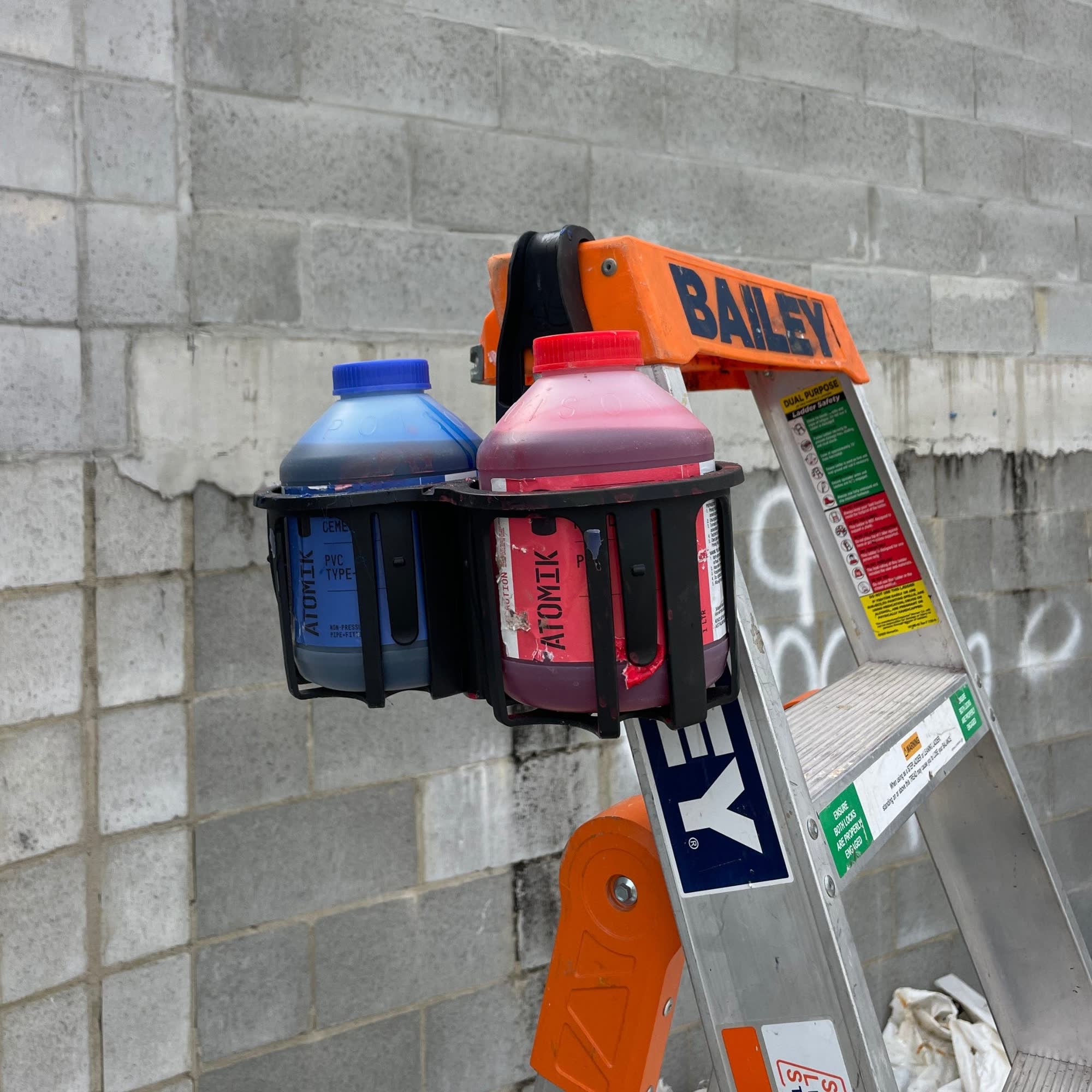 Constricta Multi Pot Grip hanging on ladder holding solvents 