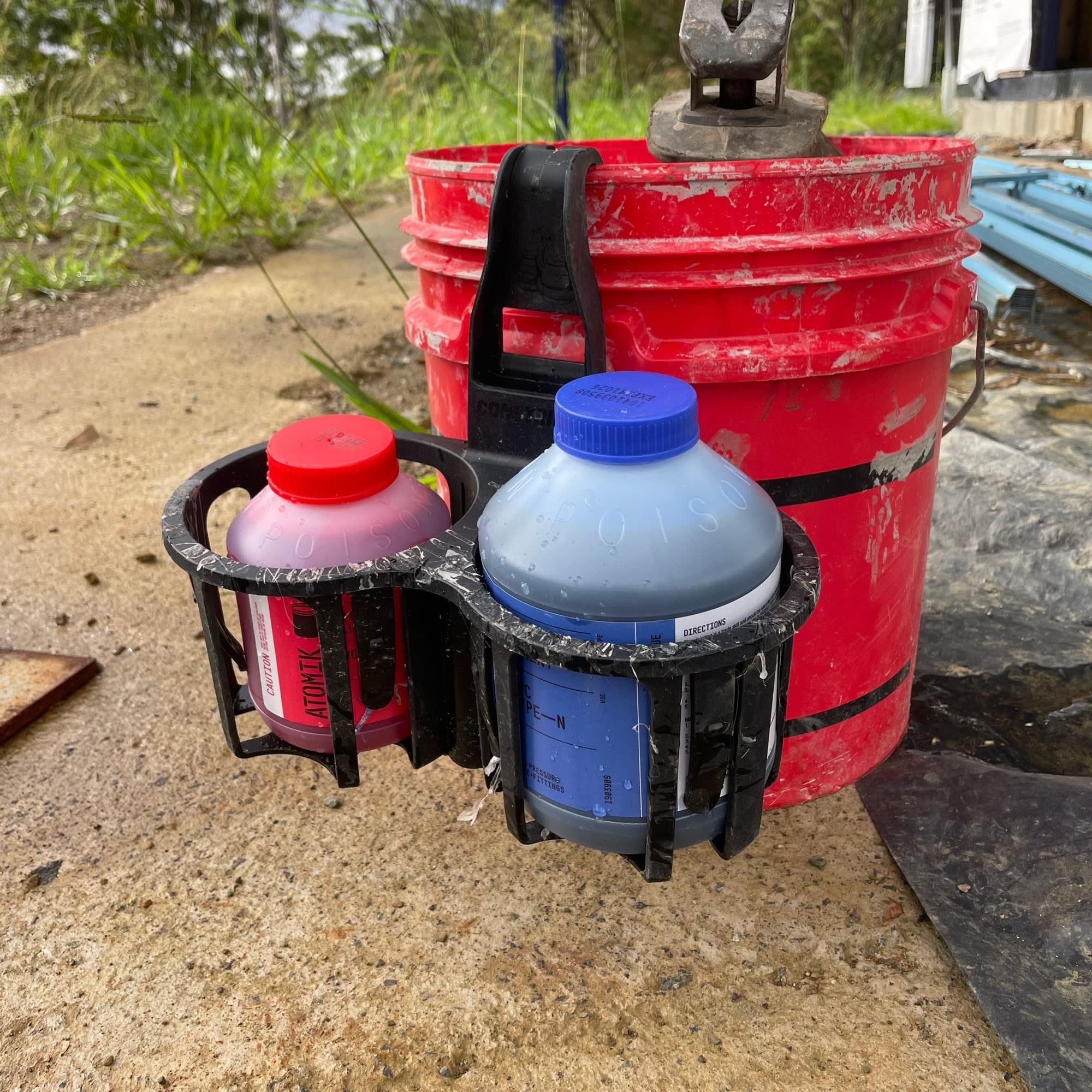 Red bucket with black constrictor, multi pot grip, holding glue and primer. 