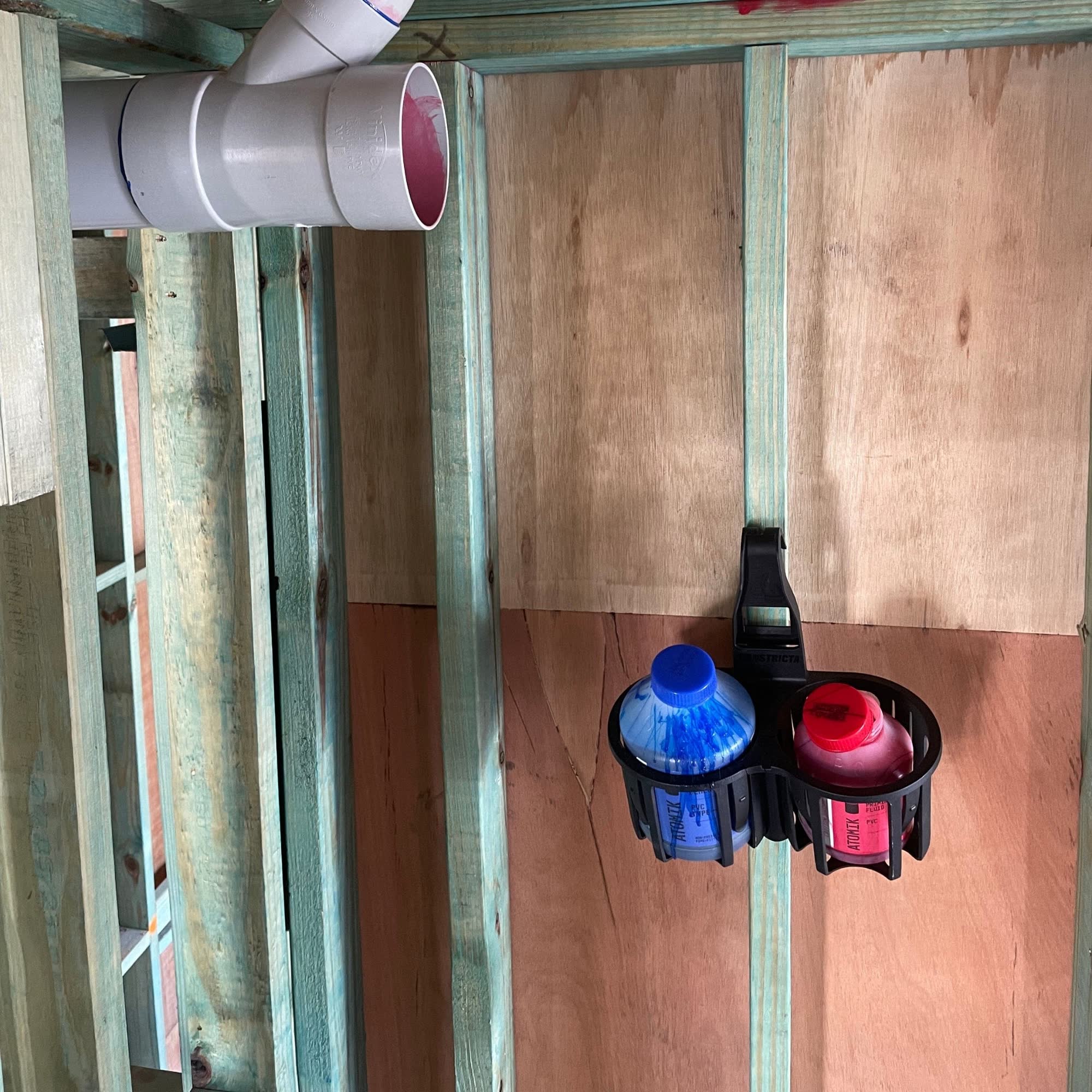 I'm installing a drainage system using PVC glue and primer using a Constricta multi-pot grip. 