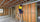 Plumber on ladder working with PVC plumbing pipes